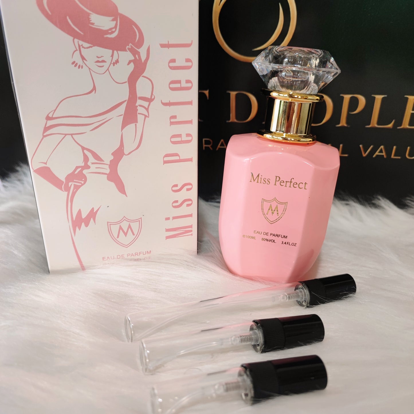 Miss Perfect by Mahabub decant vials with original pink bottle and box on white fur