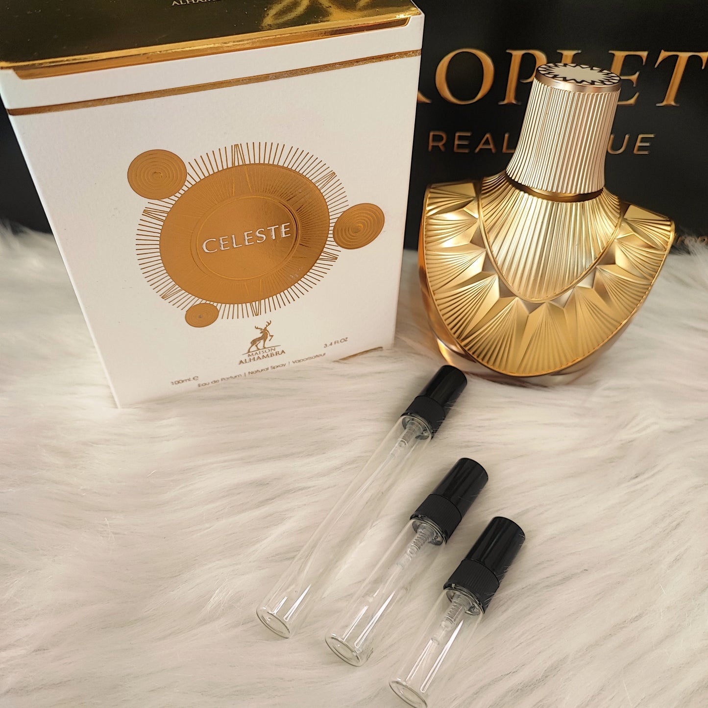 Celeste by Maison Alhambra decant vials with original bottle and box on white fur